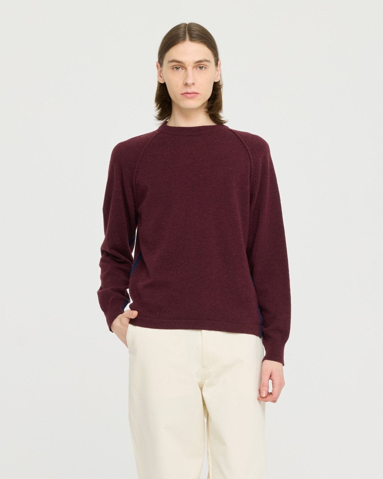 Lightweight merino wool blend knit made in Portugal with subtle contrast side detailing, soft and breathable for year-round layering. 